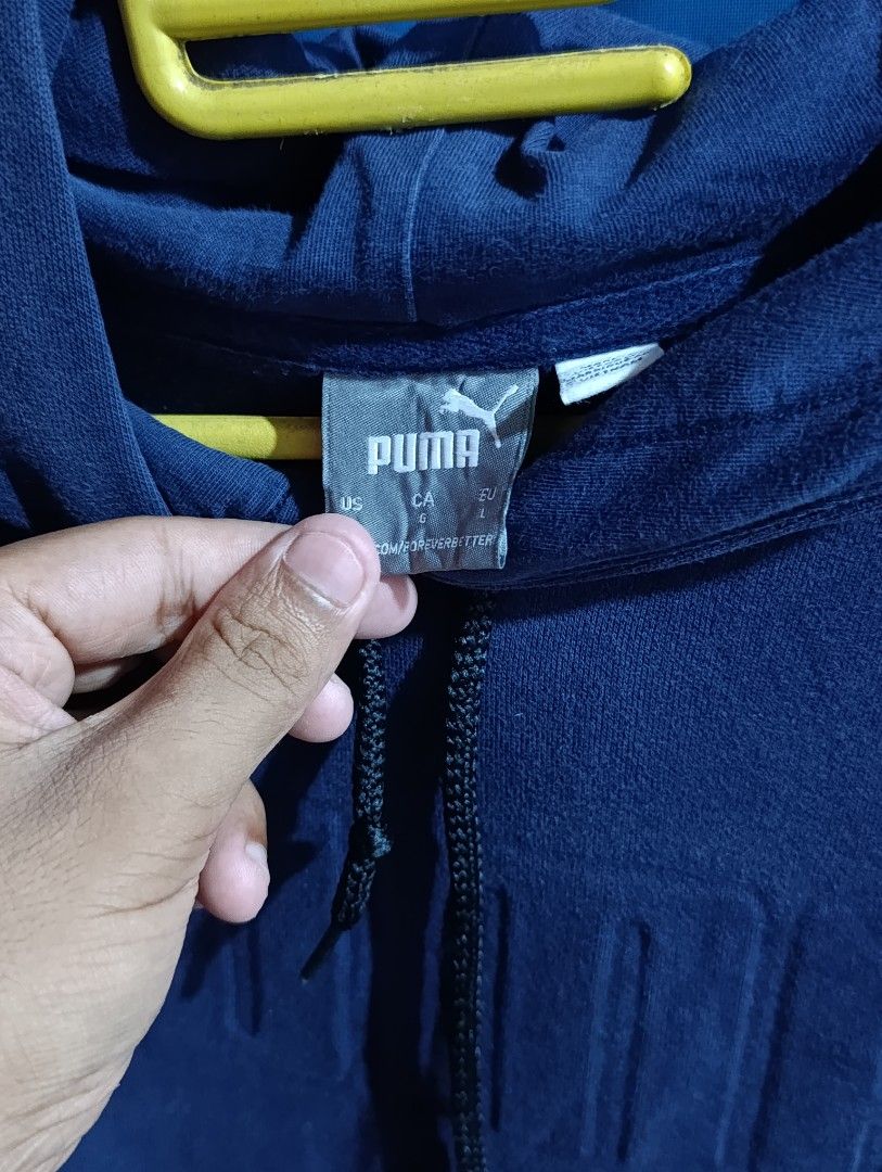 Puma Navy Blue Embossed Logo Hoodie (Category: Hoodies) located in Naga. Submitted by brightsideofthemoon (Listing ID 1446099536, Image 2). Description: - Classic navy blue Puma hoodie - Embossed Puma logo across the chest - Drawstring hood for adjustable comfort - Front kangaroo pocket - Ideal for casual wear.