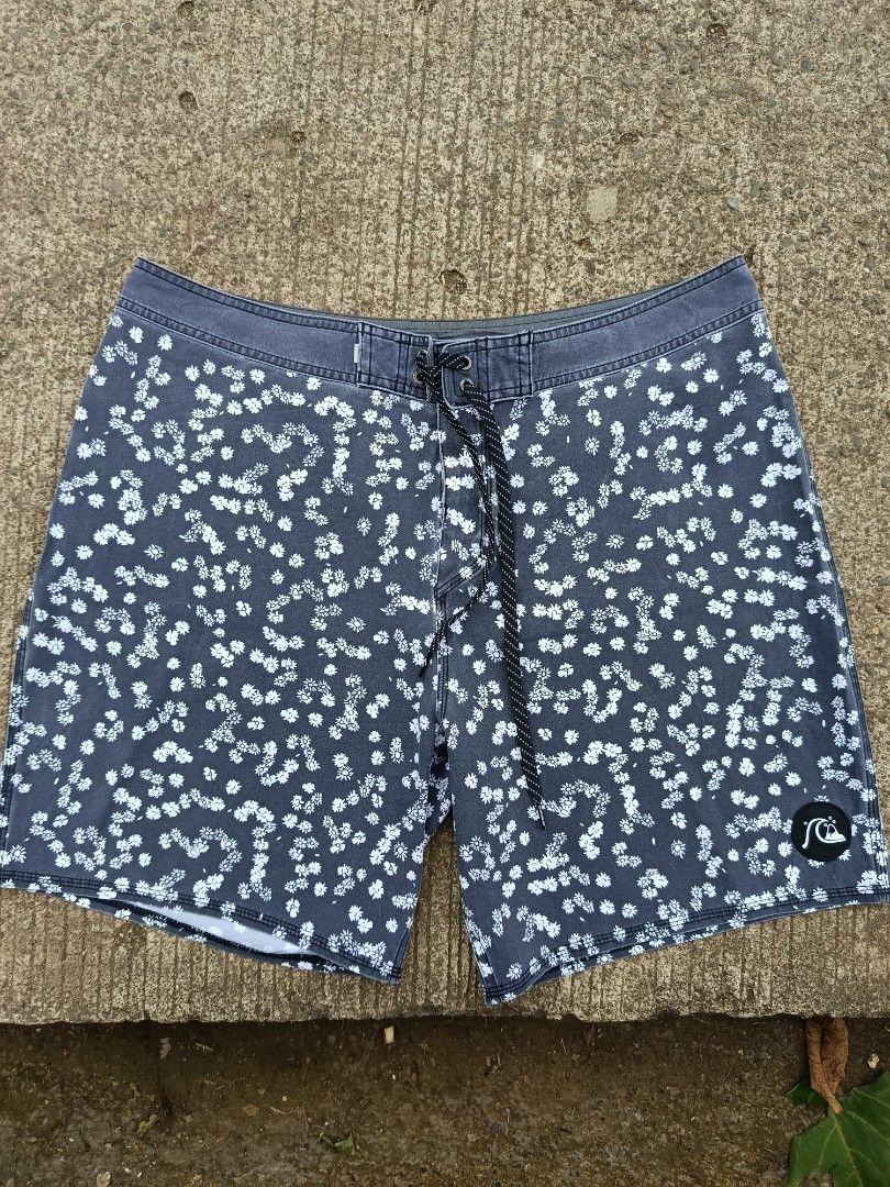 Quiksilver Highline Boardshorts Floral Pattern (Category: Swim Trunks & Board Shorts) located in Jasaan. Submitted by eliwhomp (Listing ID 1446053911, Image 1). Description: - Quiksilver boardshorts - Cool grey and white floral print - Drawstring waist - Back pocket with red pull tab - Quiksilver logo on left leg - 'Highline' model - Ideal for beach or pool.
