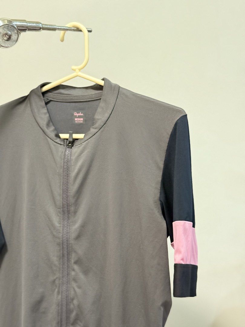 Rapha Cycling Jersey - Grey/Black/Pink - Size Medium (Category: Activewear) located in Caloocan City. Submitted by thebikebin (Listing ID 1446037052, Image 2). Description: - Rapha cycling jersey - Color: Grey body, black sleeves, pink accents - Features: Full zip front, 3 back pockets with Rapha logo - Size: Medium - Perfect for your next cycling adventure!.