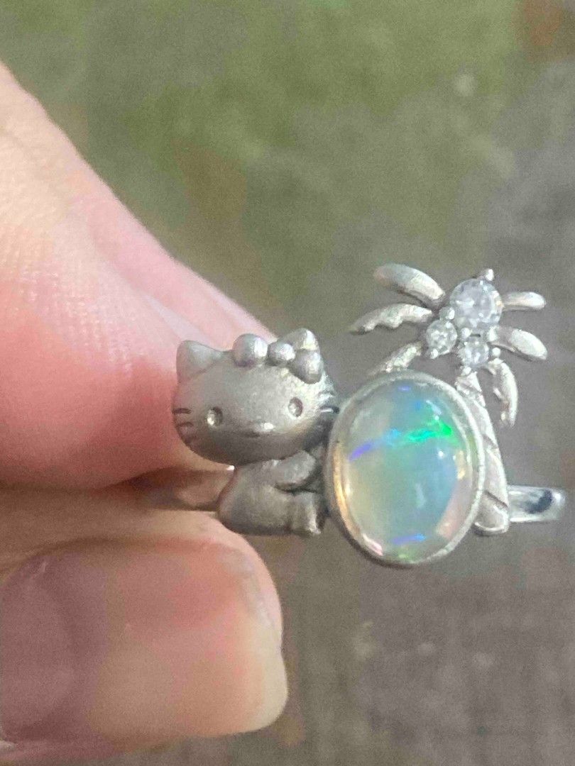 Silver Opal Hello Kitty Spider Ring (Category: Rings) located in Imus. Submitted by timelessfindph (Listing ID 1446047056, Image 1). Description: - Cute silver ring 925 - Features a Kitty design - Adorned with an opal stone - Includes a spider with small zirconia stones - Band is marked S925 - Unique piece for collectors - per piece only.