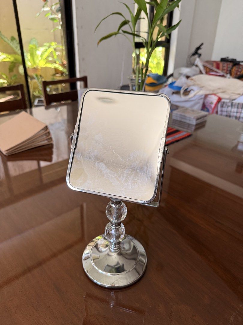Square Tabletop Mirror with Crystal Base (Category: Mirrors) located in Caloocan City. Submitted by juanpaoloi59703 (Listing ID 1446075775, Image 2). Description: - Square mirror on a stand - Shiny chrome base with clear crystal accents - Adjustable tilt feature - Ideal size for vanity or desk - Minor smudges on mirror surface - Great for makeup application or decorative display.