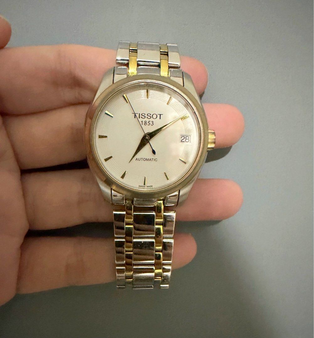 Tissot 1853 Automatic Two-Tone Watch (Category: Luxury Watches) located in Cagayan de Oro. Submitted by megflores413 (Listing ID 1445997021, Image 3). Description: - Tissot 1853 Automatic Watch - Classic white dial with date window - Stainless steel and gold-tone link bracelet - Exhibition case back showcasing automatic movement - Versatile for everyday wear or special events - In excellent working condition - Signs of wear - Watch only.