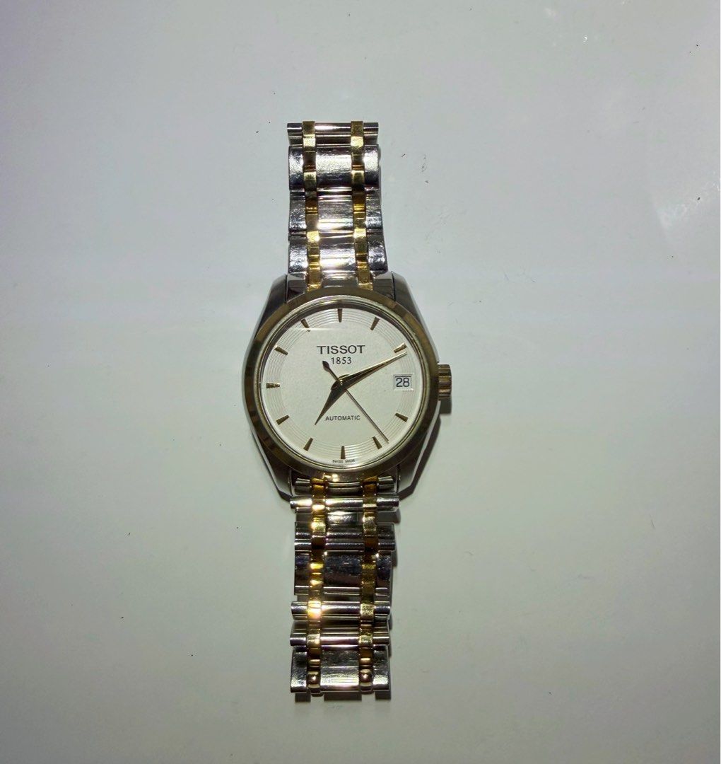 Tissot 1853 Automatic Two-Tone Watch (Category: Luxury Watches) located in Cagayan de Oro. Submitted by megflores413 (Listing ID 1445997021, Image 1). Description: - Tissot 1853 Automatic Watch - Classic white dial with date window - Stainless steel and gold-tone link bracelet - Exhibition case back showcasing automatic movement - Versatile for everyday wear or special events - In excellent working condition - Signs of wear - Watch only.