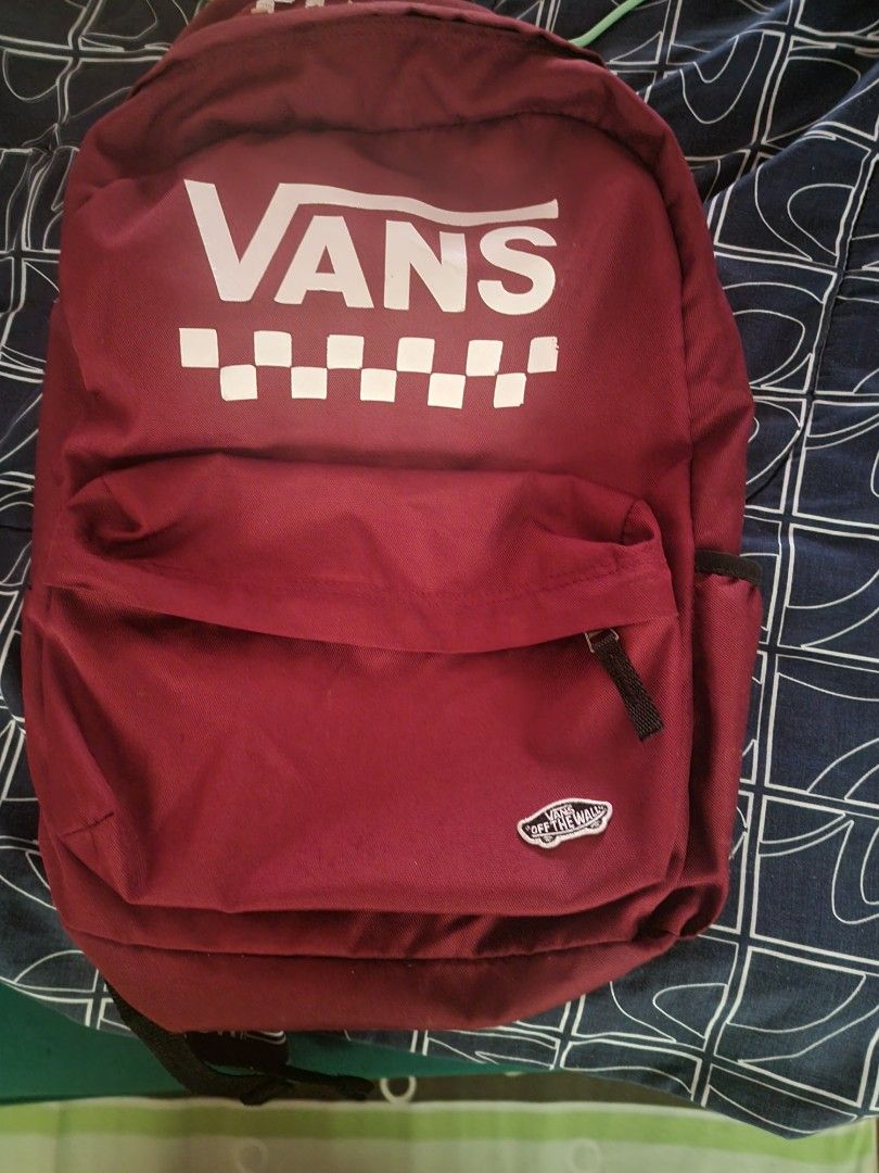 Vans Bagpack (Category: Luxury Bags & Wallets) located in Aguinaldo. Submitted by rhoullcla063142 (Listing ID 1446024176, Image 1). Description: ✅ Type: School / Daily / Travel Backpack ✅ Color: Maroon / Burgundy Red ✅ Design: Classic Vans logo + checkered print, "Off The Wall" woven patch ✅ Material: Durable thick polyester canvas, water-resistant finish ✅ Size: Standard large size (fits 15–16 inch laptop, books, notebooks, and daily essentials)