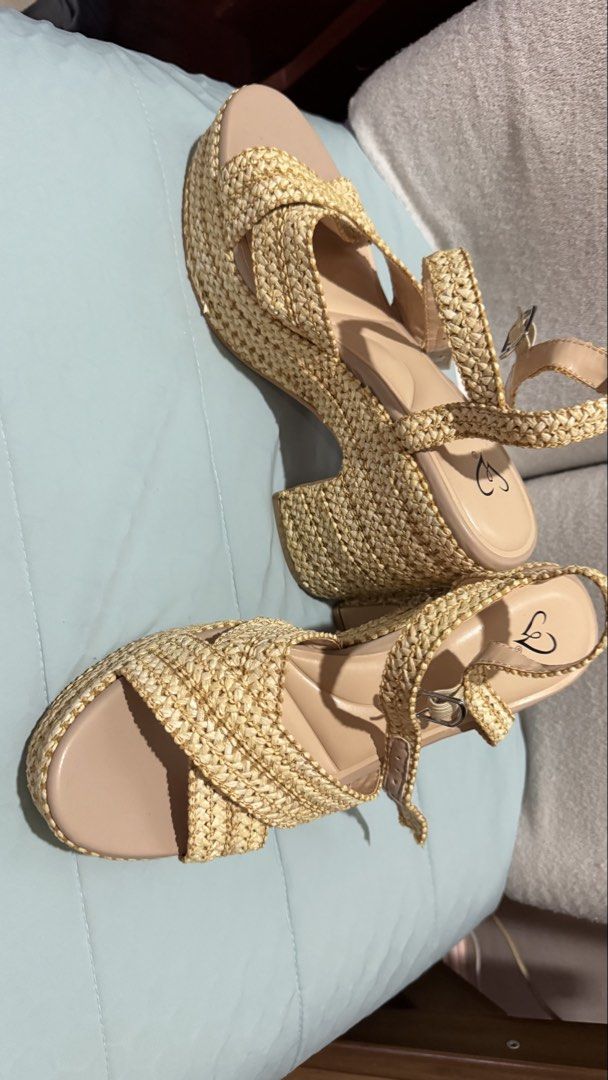 Wedge Sandals / Wedge heels / Beige heels (Category: Wedges) located in Quezon City. Submitted by gcc216 (Listing ID 1446036270, Image 2). Description: - High wedge sandals from Windsor store , Sacramento - Woven straw-like texture on platform and straps. - Straps cross over the foot with an adjustable buckle. - 'Luxe Fit Plush Support Foam' insole for comfort. - Perfect for any outfit. - Bought this in the US and never used it. - Size: 8 1/2 .