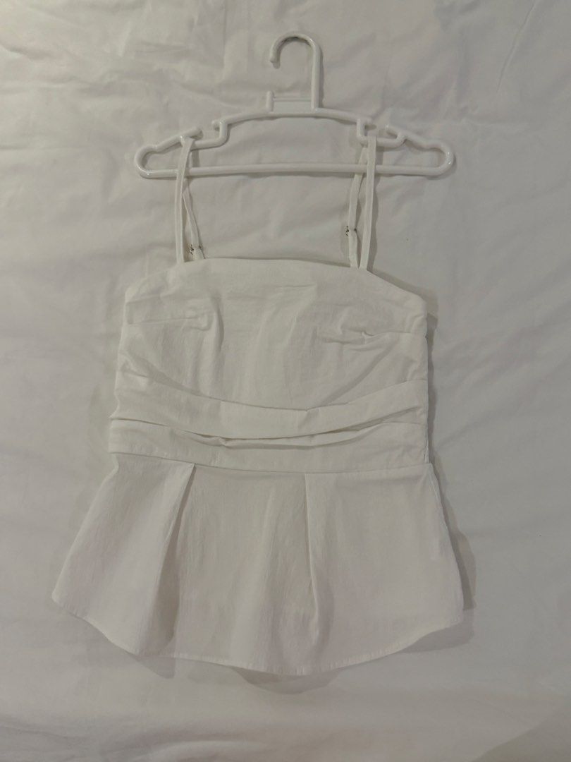 White Smocked Peplum Top (Category: Sleeveless) located in Makati City. Submitted by oursummerstitches (Listing ID 1446111074, Image 1). Description: - White peplum top - Smocked back for a comfortable fit - Adjustable straps for a customized look - Ruched detail at the waist to flatter your figure - Pleated peplum hem for a stylish flair - Estimated size: xs to s - Versatile for casual outings or dressing up - bought in Korea .