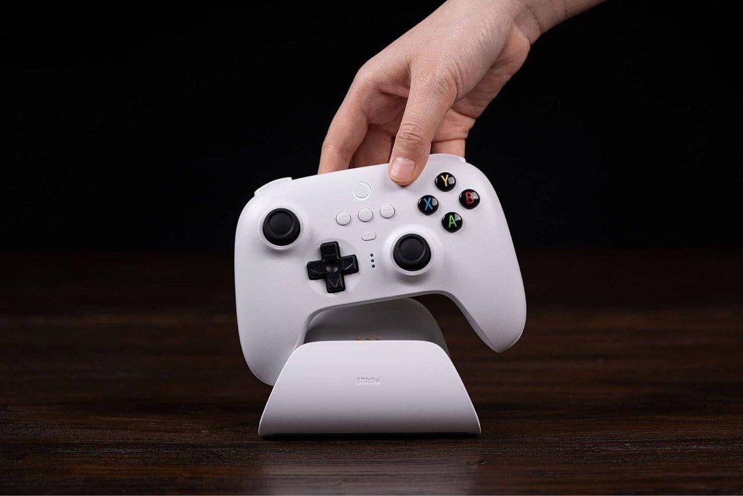 8BitDo Ultimate Bluetooth Controller White (Category: Controllers) located in Singapore. Submitted by iczelion (Listing ID 1446225583, Image 3). Description: - White 8BitDo Ultimate Bluetooth Controller - Compatible with Nintendo Switch and Windows PC - Multiple connectivity options: Bluetooth, 2.4G wireless, or USB wired - Includes charging dock for convenient power-ups - Comes with a 2.4G adapter for enhanced wireless gaming.
