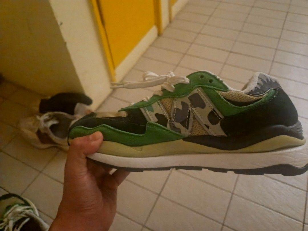A BATHING APE x New Balance 5740 Green Camo (Category: Sneakers) located in Port Dickson. Submitted by tobacco_thrift (Listing ID 1446210405, Image 2). Description: - Authentic A BATHING APE x New Balance 5740 sneakers - Striking green and black camouflage colorway - Classic lace-up closure for a secure fit - Unique and eye-catching shark tooth detail on the heel - Perfect for sneaker collectors and streetwear enthusiasts.