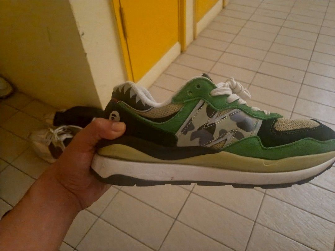 A BATHING APE x New Balance 5740 Green Camo (Category: Sneakers) located in Port Dickson. Submitted by tobacco_thrift (Listing ID 1446210405, Image 3). Description: - Authentic A BATHING APE x New Balance 5740 sneakers - Striking green and black camouflage colorway - Classic lace-up closure for a secure fit - Unique and eye-catching shark tooth detail on the heel - Perfect for sneaker collectors and streetwear enthusiasts.