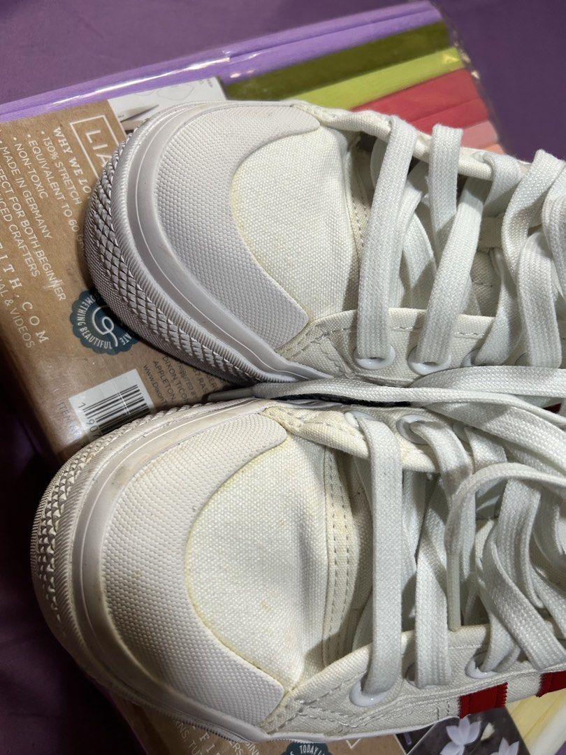 Adidas Nizza Platform White Red Stripes Sneakers (Category: Sneakers) located in Manila. Submitted by minani (Listing ID 1446230390, Image 2). Description: - White Adidas Nizza platform sneakers - Size US 8.5, can fit but tight for EU40 wide feet - Iconic red stripe detailing - Trendy chunky sole - Durable canvas material - Minor scuffs on soles and toe area (normal wear) - Plenty of life left for continued use - Ideal for everyday casual wear.