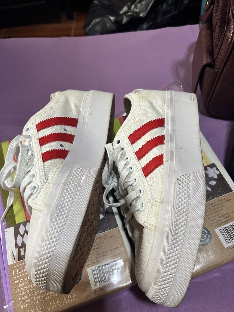 Adidas Nizza Platform White Red Stripes Sneakers (Category: Sneakers) located in Manila. Submitted by minani (Listing ID 1446230390, Image 3). Description: - White Adidas Nizza platform sneakers - Size US 8.5, can fit but tight for EU40 wide feet - Iconic red stripe detailing - Trendy chunky sole - Durable canvas material - Minor scuffs on soles and toe area (normal wear) - Plenty of life left for continued use - Ideal for everyday casual wear.