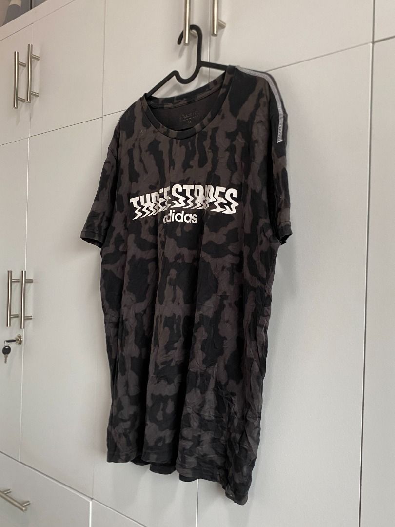 Adidas Three Stripes Camo T-Shirt (Category: Tshirts & Polo Shirts ) located in Tagaytay City. Submitted by grayl_thrift (Listing ID 1446304352, Image 2). Description: - Camouflage pattern Adidas t-shirt - Features the iconic 'Three Stripes' graphic across the chest - Adidas logo prominently displayed below the graphic.