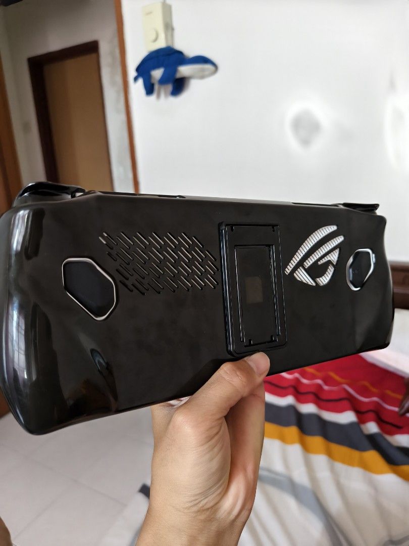 ASUS ROG Ally RC71L 2023 (Category: Others) located in Kajang. Submitted by fahlopy99-90432 (Listing ID 1446270149, Image 2). Description: - ASUS ROG Ally for sale - Ideal for gaming on the go - Comes with hardcase and silicon case - Screen is clear and buttons are responsive - Lightly Used - Features ROG logo and cooling vents on the back - Ready for your next gaming adventure - Price can nego.
