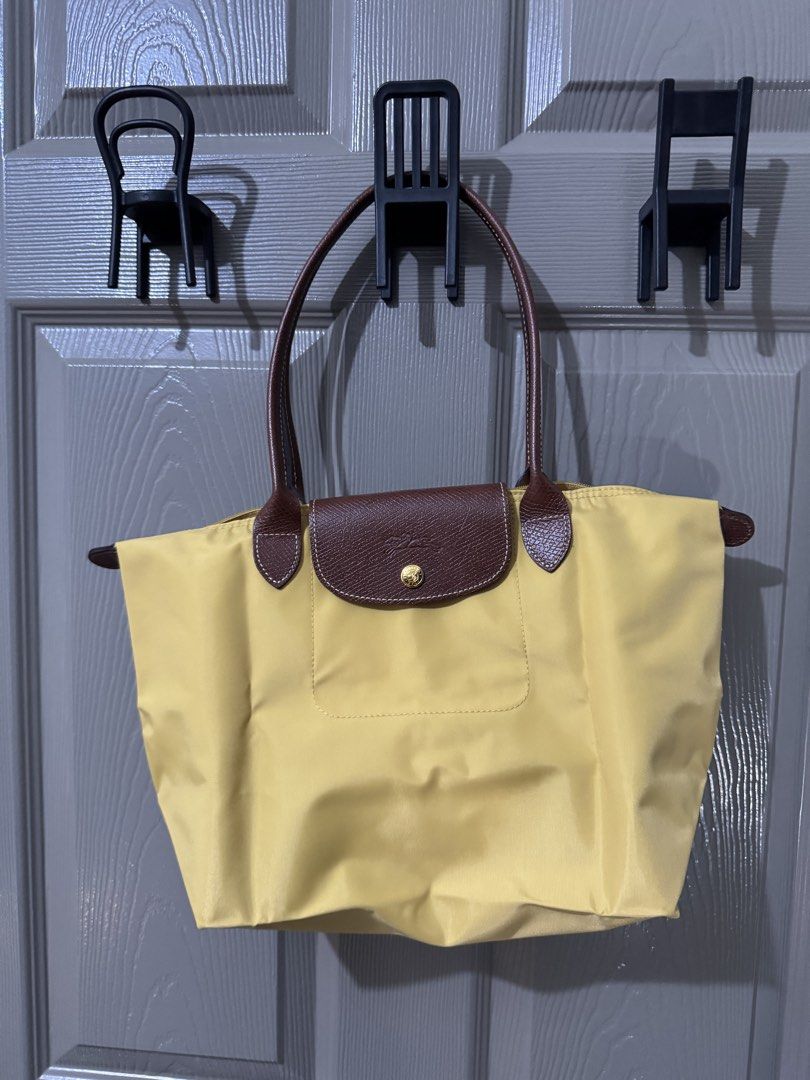 Authentic LONGCHAMP Le Pliage Original Shoulder Bag Small - Yellow (Category: Luxury Bags & Wallets) located in Quezon City. Submitted by afpar (Listing ID 1446244403, Image 1). Description: - Yellow Longchamp tote bag - Genuine leather handles and trim - Secure zipper closure with snap button flap - Interior zippered pocket for essentials - Ideal for everyday use with generous storage capacity.