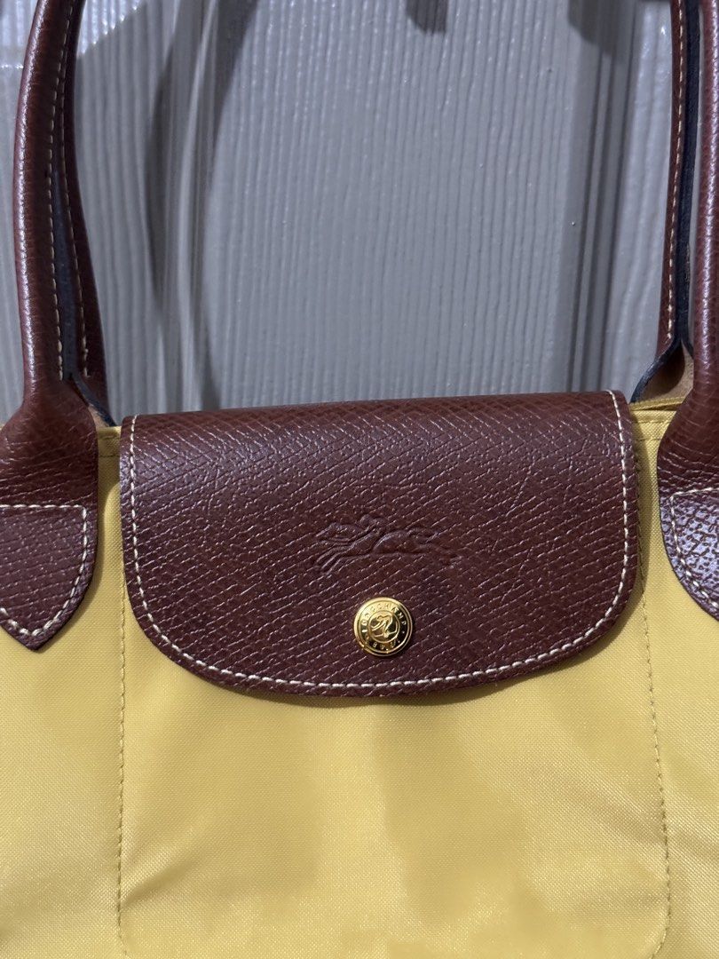Authentic LONGCHAMP Le Pliage Original Shoulder Bag Small - Yellow (Category: Luxury Bags & Wallets) located in Quezon City. Submitted by afpar (Listing ID 1446244403, Image 2). Description: - Yellow Longchamp tote bag - Genuine leather handles and trim - Secure zipper closure with snap button flap - Interior zippered pocket for essentials - Ideal for everyday use with generous storage capacity.