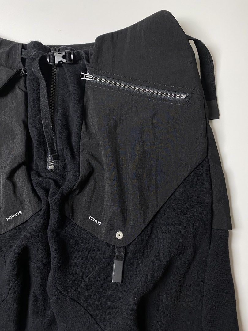 AW21 HAMCUS PRMTVSM UTILITY DROP CROTCH SHORTS (Category: Luxury Apparel) located in Balanga. Submitted by faded_garmz (Listing ID 1446213380, Image 3). Description: AW21 HAMCUS PRMTVSM UTILITY DROP CROTCH SHORTS The brand heavily integrates dystopian,, warcore aesthetics using deep garment-dyeing techniques, asymmetric cuts, and functional hardware like Fidlock buckles and modular straps HAMCUS collections are built around fictional storylines a