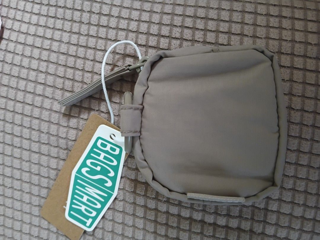 BAGSMART Quilted mini Pouch (Category: Purses & Pouches) located in Cagayan de Oro. Submitted by authenticstuffsdecluttering (Listing ID 1446219083, Image 2). Description: - Brand: BAGSMART - Style: Small quilted pouch - Color: Tan - Closure: Zipper - Features: Wrist strap - Perfect for: Organizing small items like coins, earbuds - Condition: New with original tags attached.