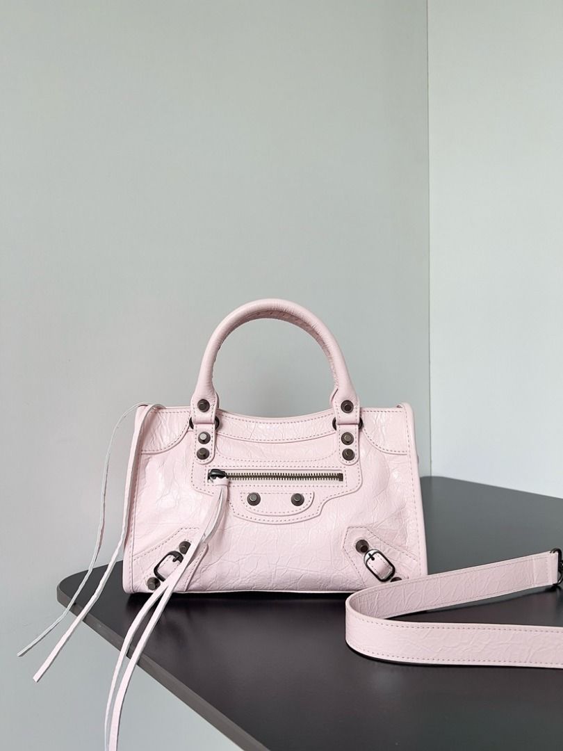 Balenciaga Pink Leather City Mini Handbag (Category: Luxury Bags & Wallets) located in San Juan City. Submitted by kaprizrazm31221 (Listing ID 1446238521, Image 1). Description: - Pink Balenciaga City Mini bag - Textured leather with classic hardware - Top handles and detachable shoulder strap - Front zippered pocket - Clean interior - Ideal size for essentials.