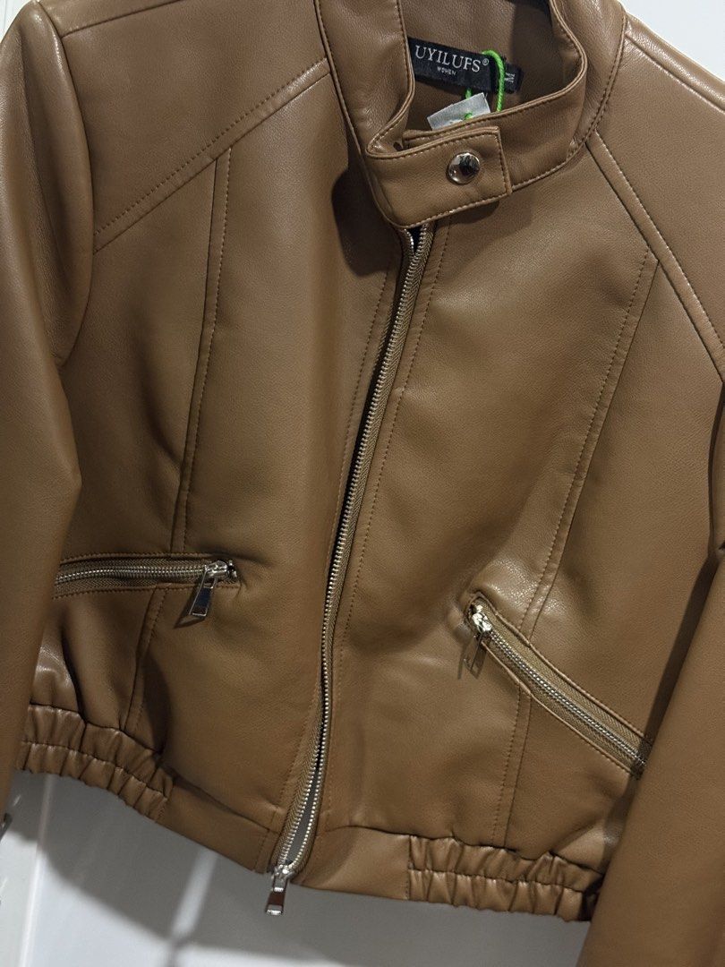 BKK Brown Leather Jacket (Category: Coats, Jackets and Outerwear) located in Pasay City. Submitted by andreaflo (Listing ID 1446200683, Image 3). Description: 🍂 brown leather jacket bought from BKK 🤎 best fits M–L; loose/oversized on S frames 🤎 used ONLY once for travel; GOOD AS BRAND NEW (already dry cleaned) 🍂 zip-up front closure 🍂 zippered pockets for essentials 🍂 button detail at the collar 🤎 ideal for layering over outfits 🏷️ Php180