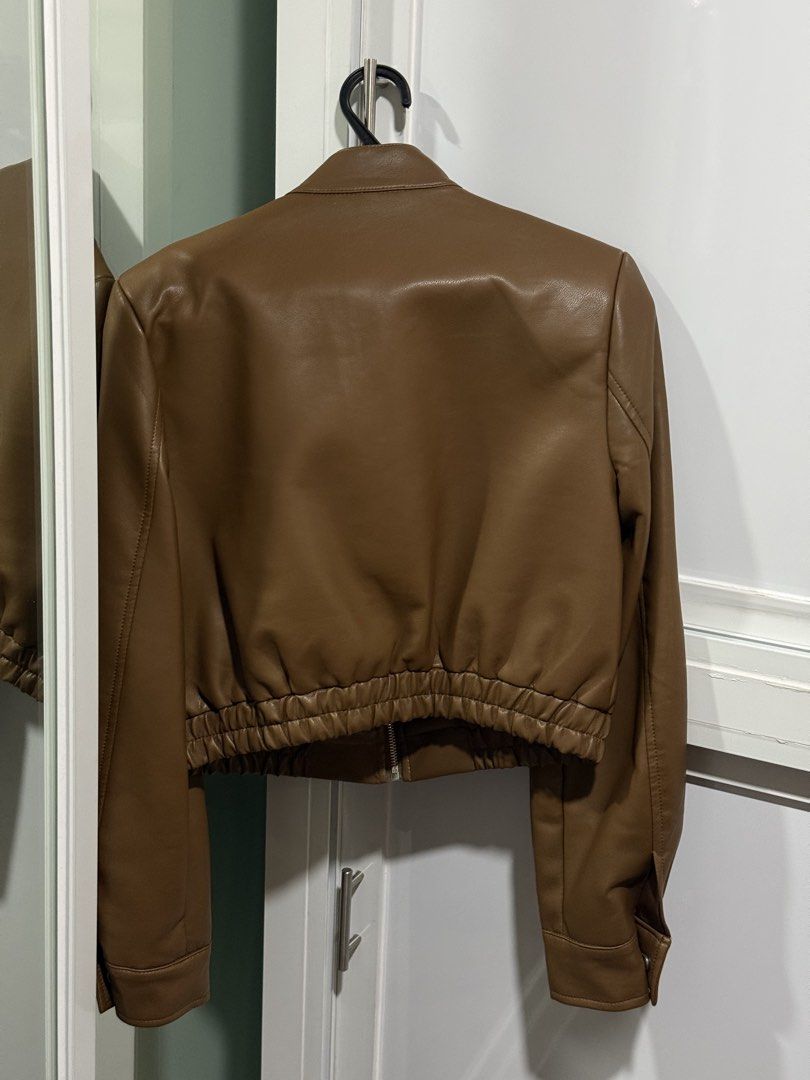 BKK Brown Leather Jacket (Category: Coats, Jackets and Outerwear) located in Pasay City. Submitted by andreaflo (Listing ID 1446200683, Image 2). Description: 🍂 brown leather jacket bought from BKK 🤎 best fits M–L; loose/oversized on S frames 🤎 used ONLY once for travel; GOOD AS BRAND NEW (already dry cleaned) 🍂 zip-up front closure 🍂 zippered pockets for essentials 🍂 button detail at the collar 🤎 ideal for layering over outfits 🏷️ Php180
