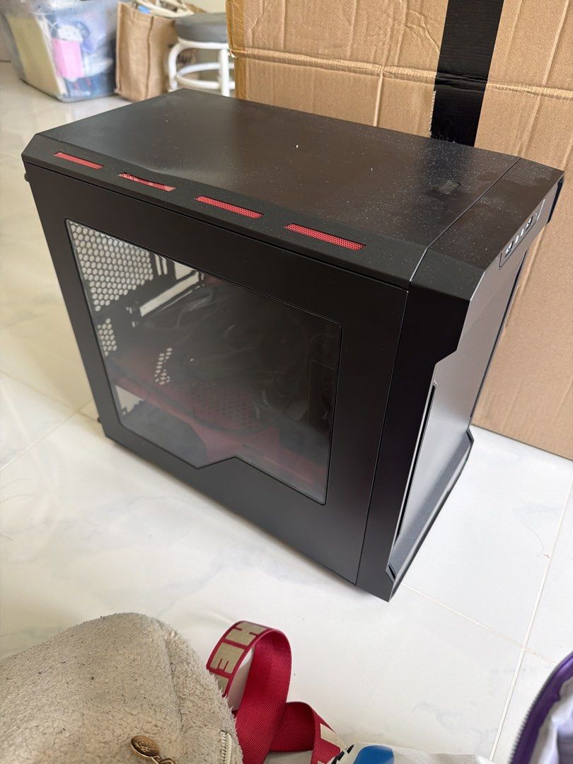 Black ATX Mid Tower PC Case with Red Accents (Category: Computer Parts) located in Singapore. Submitted by jaydenlkx (Listing ID 1446194981, Image 1). Description: - Black ATX Mid Tower PC Case - Features striking red accents on top and front - Comes with multiple NZXT fans for excellent cooling - Side panel with a window to showcase your build - Designed for optimal airflow - Ready for your PC assembly - Note: Minor dent on the top surface.