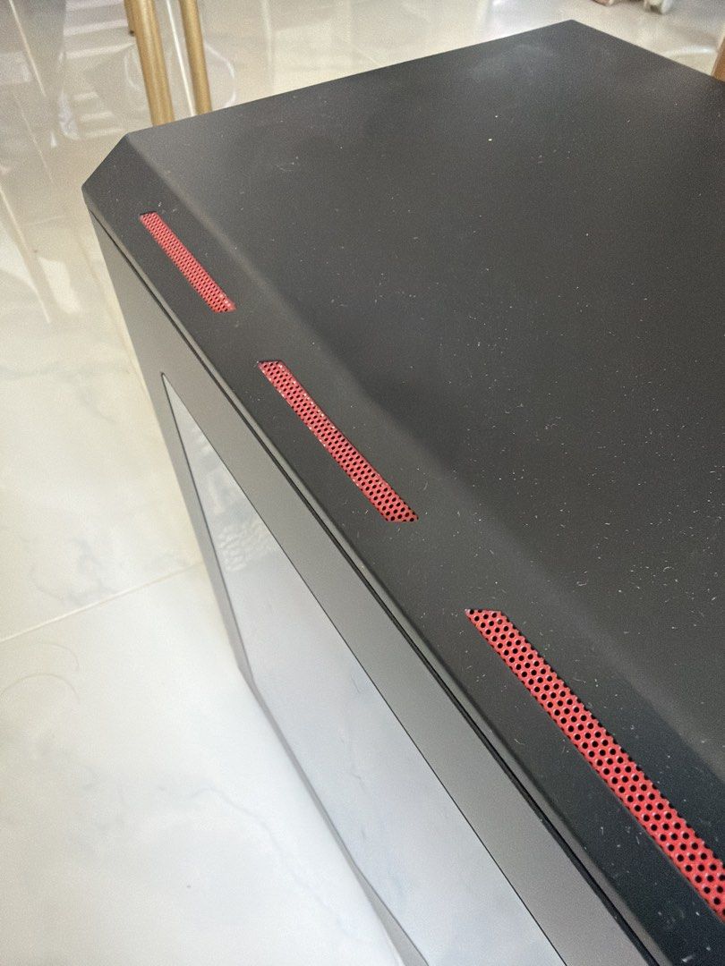 Black ATX Mid Tower PC Case with Red Accents (Category: Computer Parts) located in Singapore. Submitted by jaydenlkx (Listing ID 1446194981, Image 2). Description: - Black ATX Mid Tower PC Case - Features striking red accents on top and front - Comes with multiple NZXT fans for excellent cooling - Side panel with a window to showcase your build - Designed for optimal airflow - Ready for your PC assembly - Note: Minor dent on the top surface.