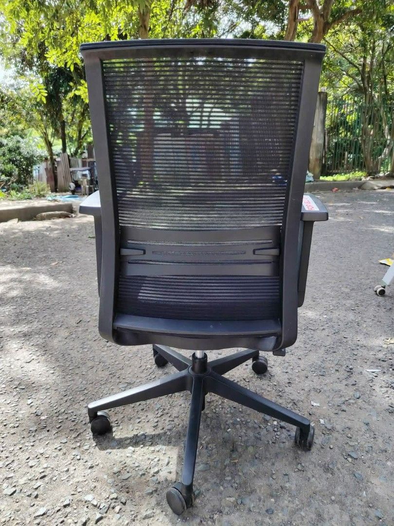 Black Ergonomic Mesh Office Chair with Armrests (Category: Office Furniture & Fixtures) located in Muntinlupa City. Submitted by freestone_d54257 (Listing ID 1446245685, Image 3). Description: - Black ergonomic office chair - Breathable mesh back for comfort - Padded seat for extended sitting - Adjustable armrests for personalized support - Five-star base with wheels for easy mobility - Ideal for home office setups - Good overall condition.