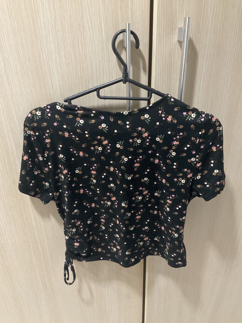 Black Floral Wrap Crop Top (Category: Blouses) located in San Juan City. Submitted by rctdeclutter_ (Listing ID 1446285483, Image 2). Description: - Black Ditsy floral print - Wrap front design - Short sleeves - Side drawstring detail - Versatile for casual or dressed-up outfits - washrd but never worn.