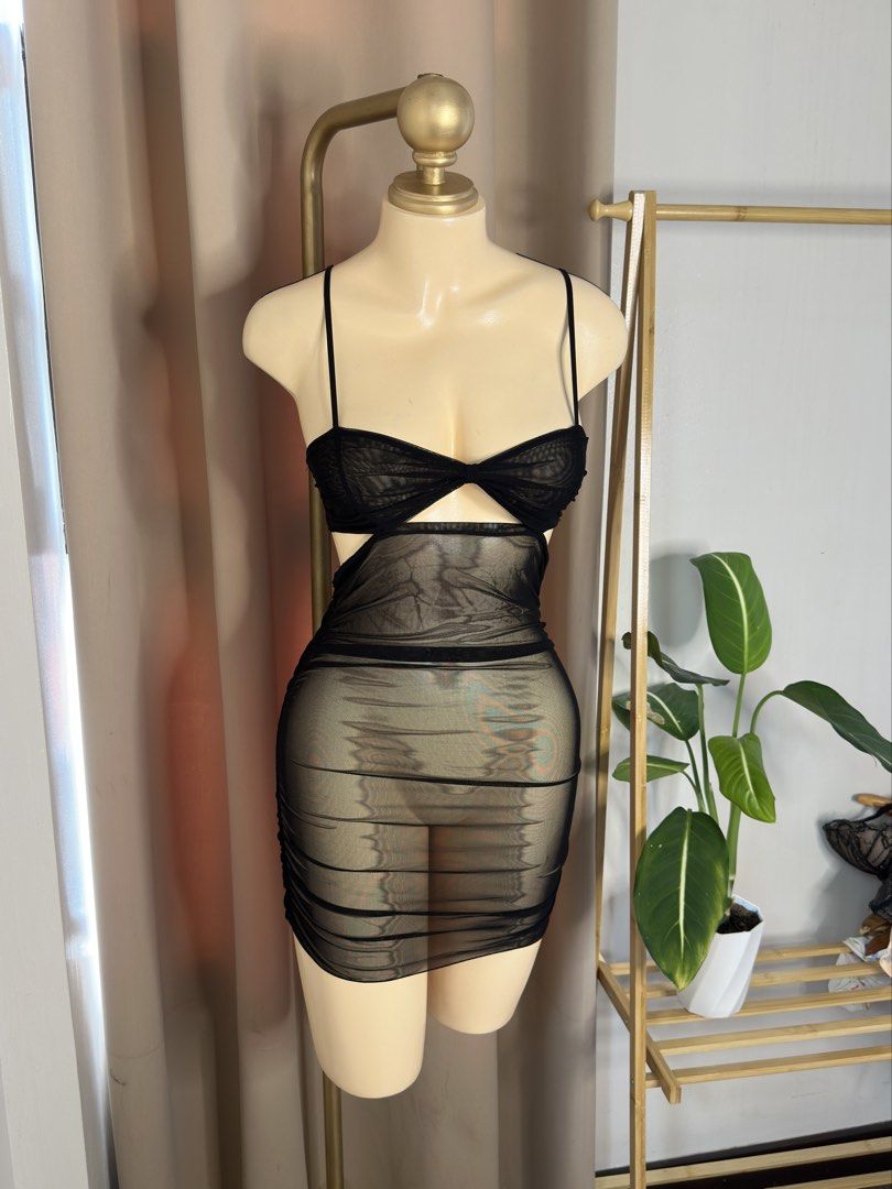 Black Mesh Cutout Bodycon Mini Dress (Category: Dresses) located in Angeles City. Submitted by xandra25 (Listing ID 1446302186, Image 1). Description: - Sheer black mesh mini dress - Cutout detail at the bust - Ruched skirt for a flattering silhouette - Delicate spaghetti straps - Perfect for parties and nights out - Very flattering fit.