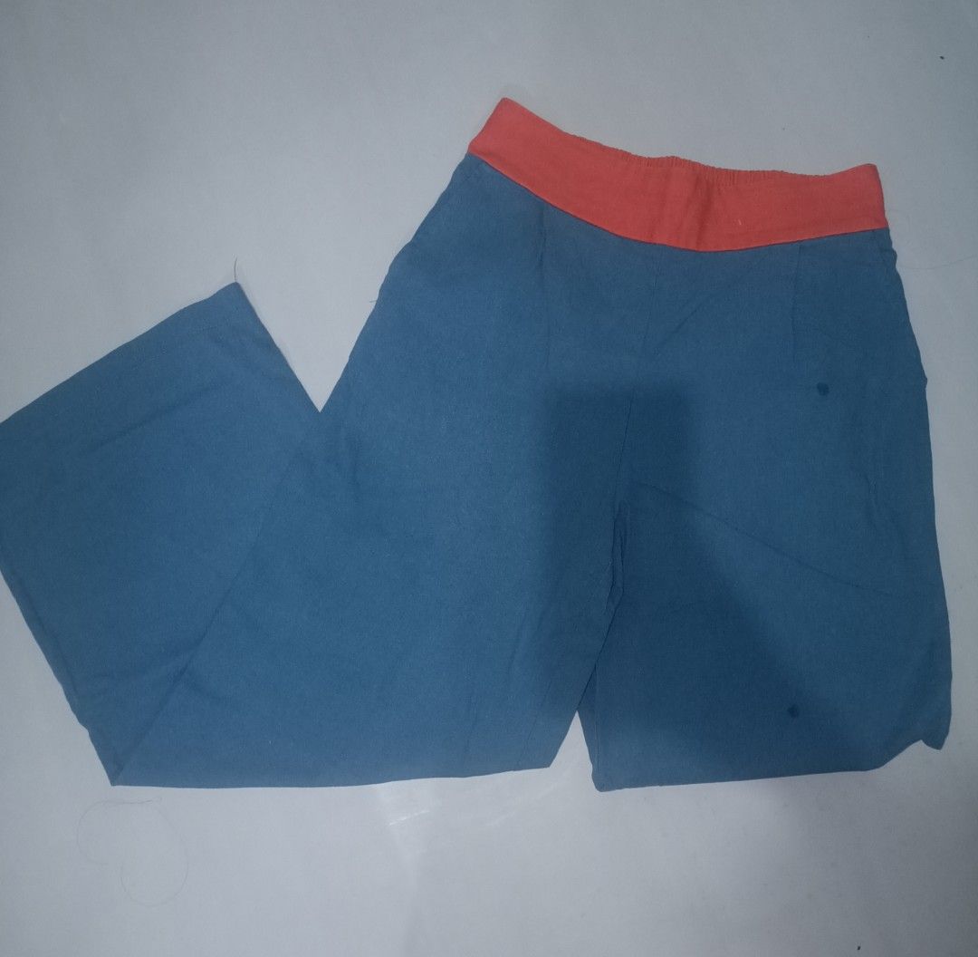 Blue Pants with Orange Waistband (Category: Other Bottoms) located in Las Pinas. Submitted by ZHOEYCLOTHING (Listing ID 1446297431, Image 1). Description: - Stylish blue wide-leg pants - Features a contrasting orange elastic waistband - Ideal for everyday casual wear.