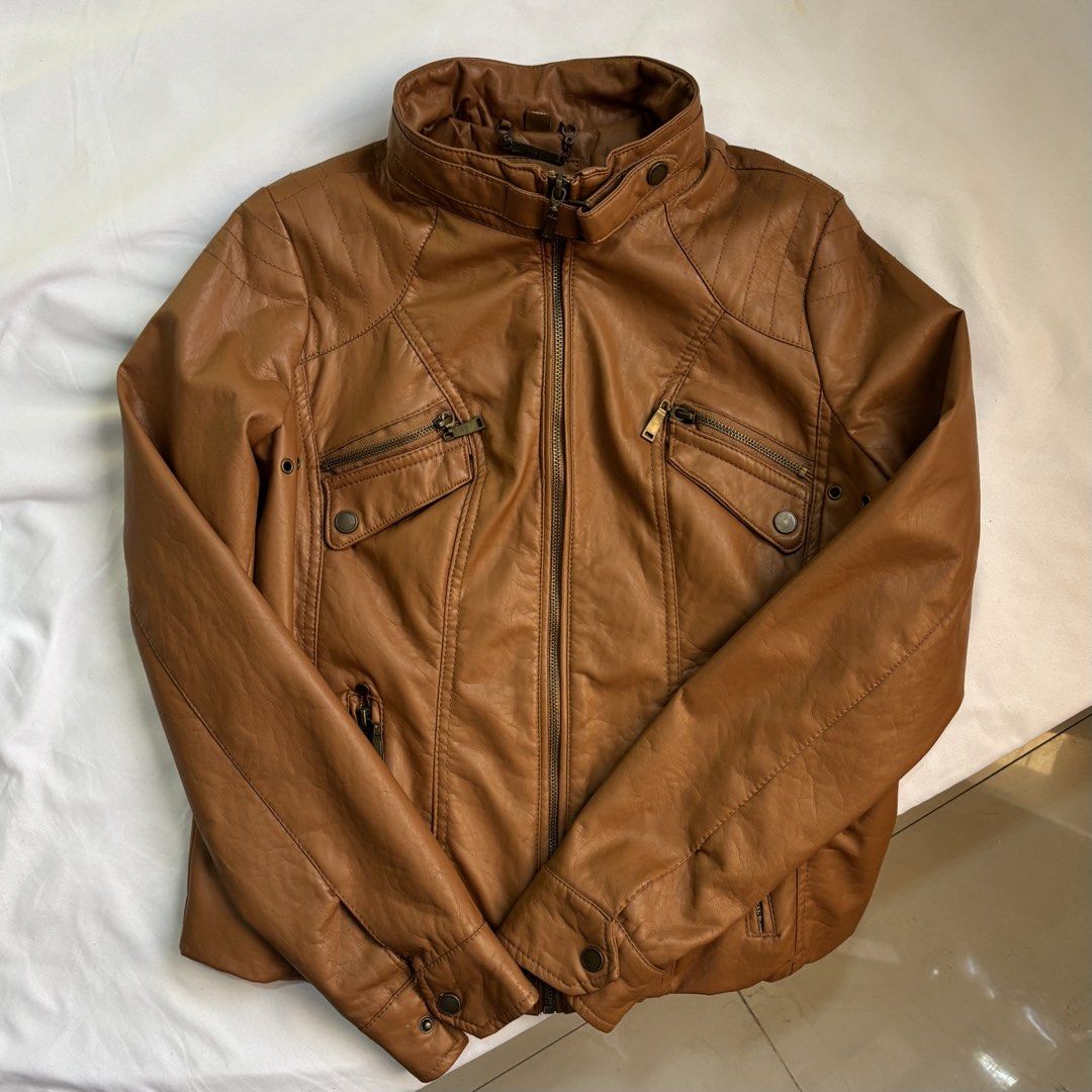 Brown Faux Leather Moto Jacket (Category: Coats, Jackets and Outerwear) located in Caloocan City. Submitted by closetclean_out (Listing ID 1446254864, Image 3). Description: - Cool brown faux leather moto jacket - Zipper front with multiple pockets - Stand-up collar with snap details - Versatile for casual wear or a night out Size: Length- 22” Bust- 20” Sleeves-28” Hem-19”.