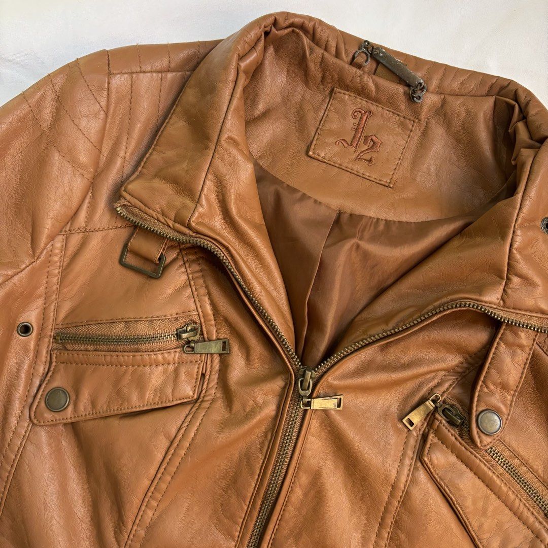 Brown Faux Leather Moto Jacket (Category: Coats, Jackets and Outerwear) located in Caloocan City. Submitted by closetclean_out (Listing ID 1446254864, Image 2). Description: - Cool brown faux leather moto jacket - Zipper front with multiple pockets - Stand-up collar with snap details - Versatile for casual wear or a night out Size: Length- 22” Bust- 20” Sleeves-28” Hem-19”.