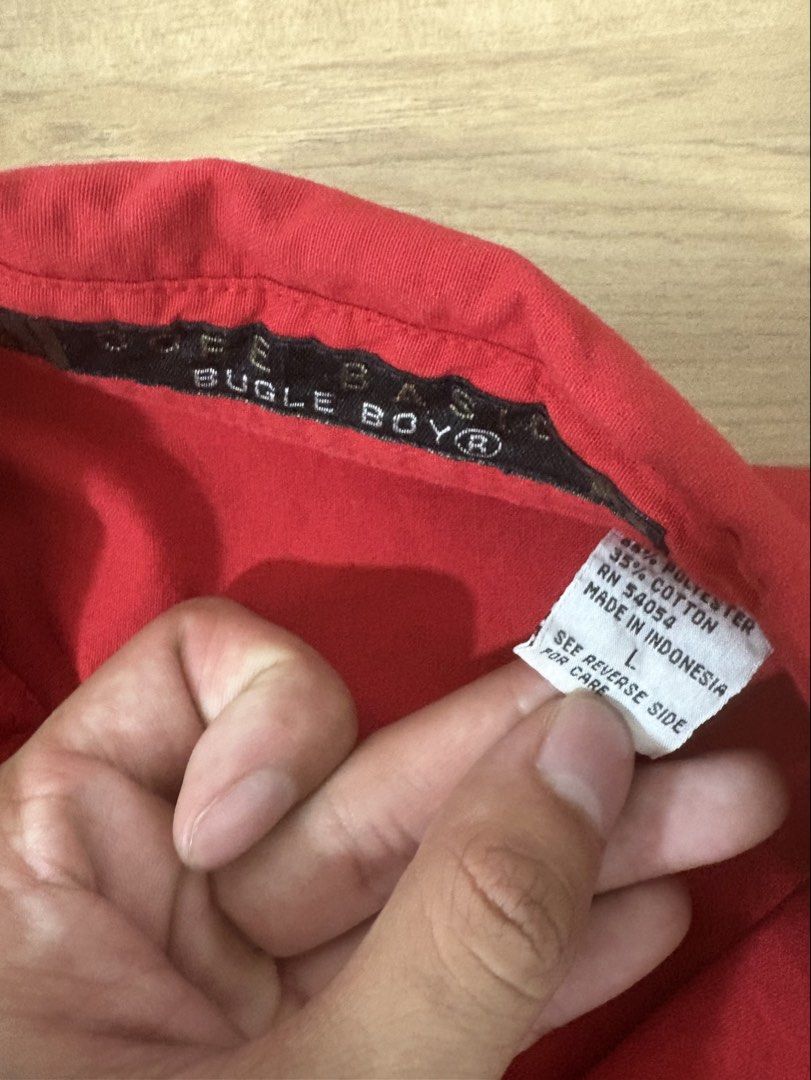 Bugle Boy Red Short Sleeve Button Up Shirt Size L (Category: Tshirts & Polo Shirts ) located in Manila. Submitted by baydenbones (Listing ID 1446249499, Image 2). Description: Bugle Boy red short sleeve button-up shirt, size L. Features two chest pockets with a small embroidered logo. Hem is cut/frayed. Made in Indonesia..