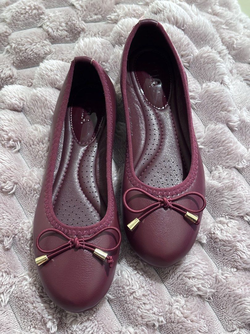 Ballet Flats with Bow Detail (Category: Flats & Sandals) located in Caloocan City. Submitted by stuff_shop (Listing ID 1446276572, Image 1). Description: - Chic burgundy ballet flats - Adorable bow detail with gold accents - Comfortable perforated insole - Easy slip-on design - Versatile for casual or dressed-up looks - Size 35 .