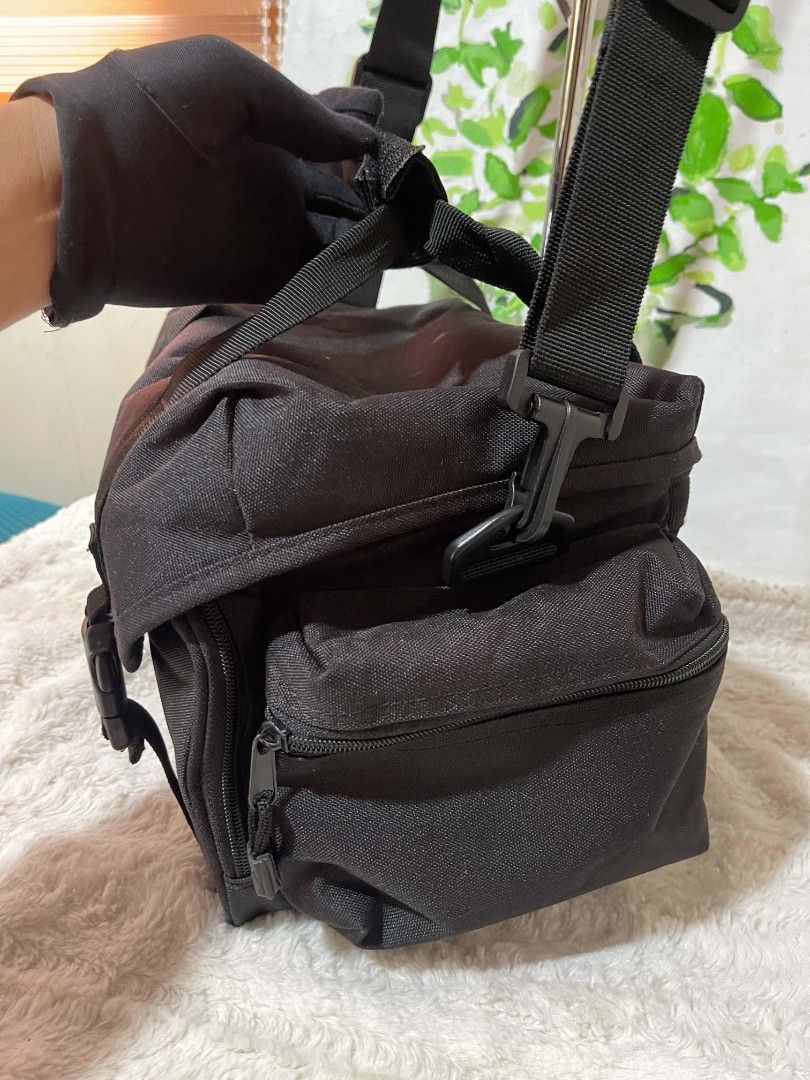 Canon Black Camera Bag with Adjustable Strap (Category: Camera Bags & Carriers) located in Naawan. Submitted by twilly.apparel2 (Listing ID 1446185863, Image 3). Description: - Genuine Canon camera bag - Durable material for protection - Spacious main compartment for camera - Convenient side pockets for accessories - Adjustable shoulder strap for comfortable carrying - Secure buckle closures on front flap.