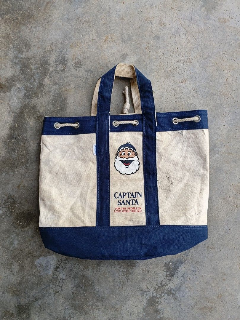 Captain Santa Canvas Tote Bag (Category: Tote Bags) located in Tanah Merah. Submitted by paka_store (Listing ID 1446234358, Image 2). Description: - Cute Captain Santa graphic on front - Canvas Kain tebal - Secure drawstring closure - Perfect for everyday errands or beach trips - Used item with minor marks, as expected - Ada stain biasa / belum cuci / belum restore / jual seadanya - Pos Dfod.