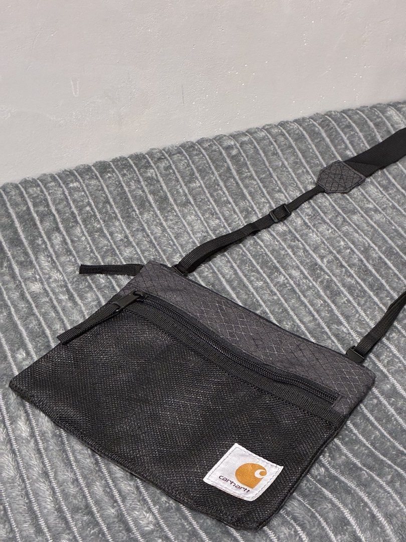 Carhartt Sprey Strap Sling Bag Black (Category: Sling Bags) located in Tarlac. Submitted by ayla.shop (Listing ID 1435082238, Image 1). Description: - Carhartt Crossbody Bag - Main compartment with zipper - Front pocket with zipper - Adjustable shoulder strap - Unique diamond pattern - Features the Carhartt logo - Condition: 9.5/10 Almost Brandnew Meet up or plus shipping via LBC Express (COD/COP/Gcash/BankTransfer).