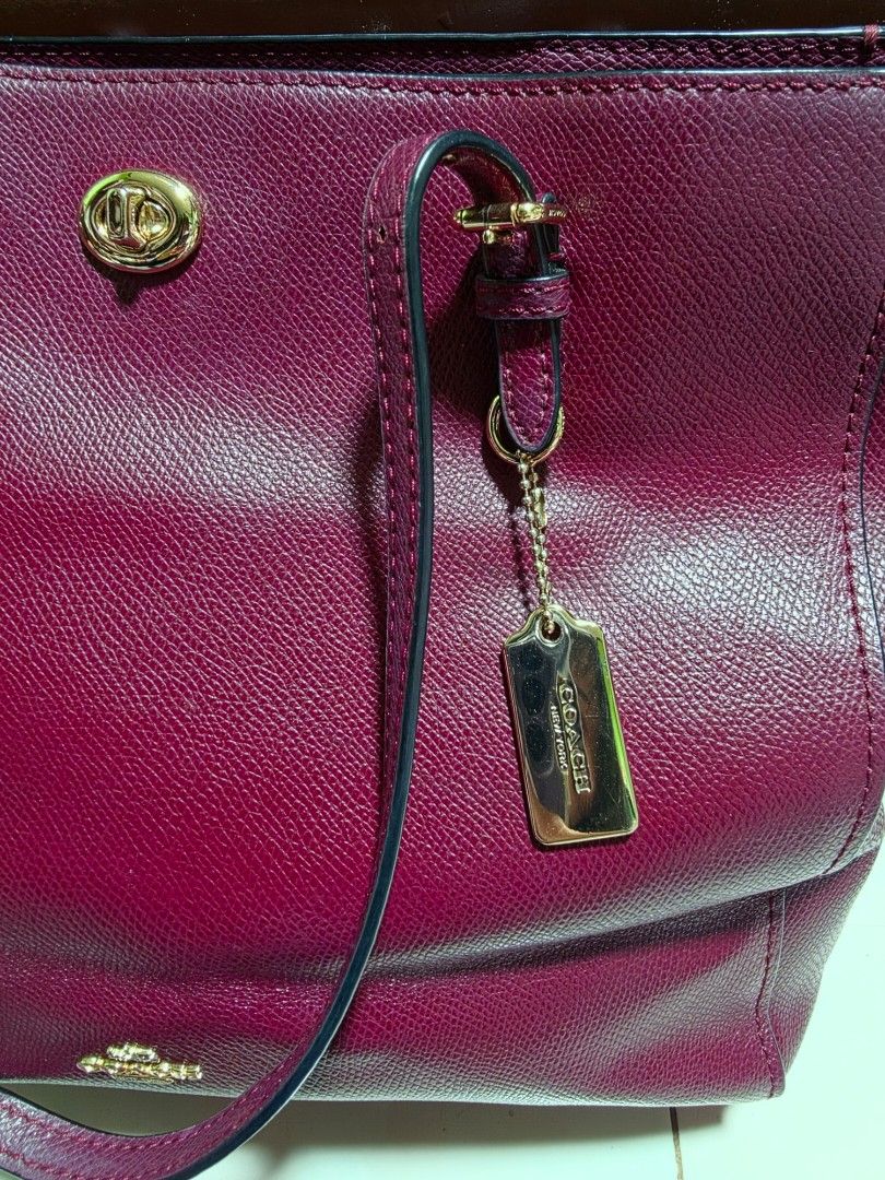 Coach Burgundy Leather Tote Bag (Category: Luxury Bags & Wallets) located in San Mateo. Submitted by bambags (Listing ID 1446288763, Image 2). Description: - Authentic Coach burgundy tote bag - Textured leather with elegant gold hardware - Spacious main compartment - Interior zip pocket for essentials - Comes with original Coach hang tag - Ideal for everyday style and functionality.