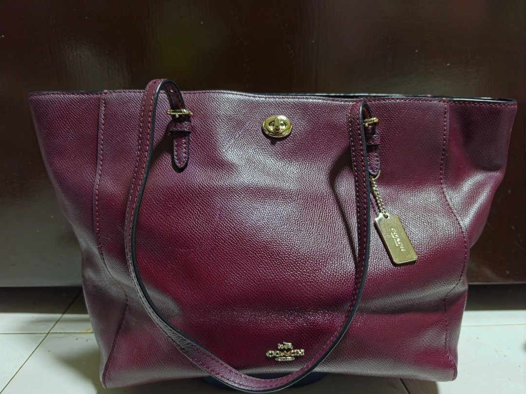 Coach Burgundy Leather Tote Bag (Category: Luxury Bags & Wallets) located in San Mateo. Submitted by bambags (Listing ID 1446288763, Image 1). Description: - Authentic Coach burgundy tote bag - Textured leather with elegant gold hardware - Spacious main compartment - Interior zip pocket for essentials - Comes with original Coach hang tag - Ideal for everyday style and functionality.