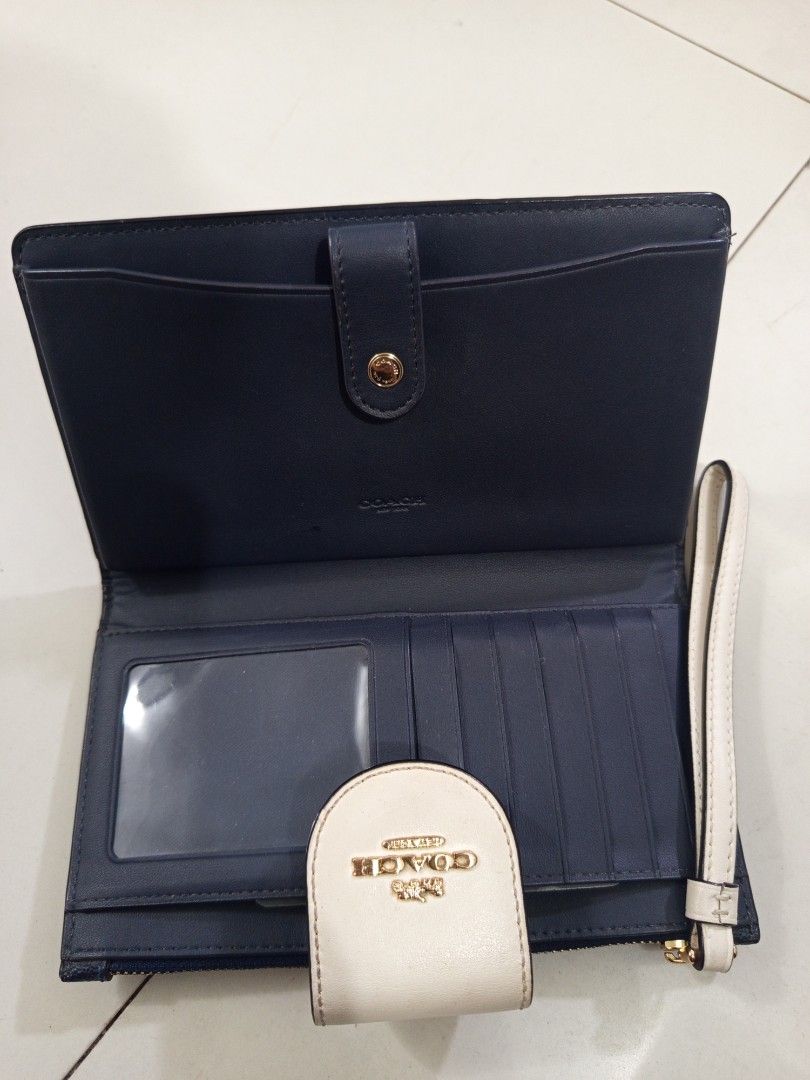 Coach Signature Double Zip Wallet (Category: Luxury Bags & Wallets) located in Manila. Submitted by harvys2038 (Listing ID 1446197649, Image 2). Description: - Authentic Coach wallet - Signature pattern - Navy blue interior - Multiple card slots and clear ID window - Zippered compartment - Secure flap closure with gold Coach logo.