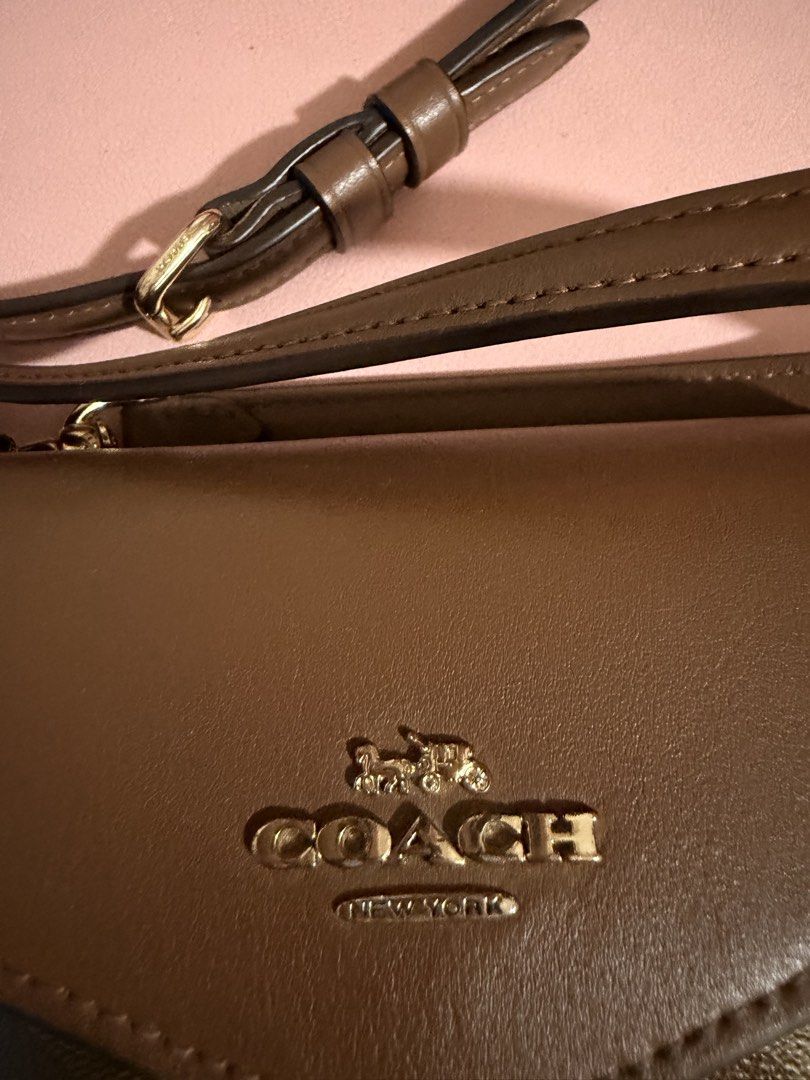 Coach Wallet on Chain (Category: Luxury Bags & Wallets) located in Taguig. Submitted by marshmy (Listing ID 1446309875, Image 2). Description: Coach wallet on chain. Signature C print in brown and tan. Leather flap and strap. Gold hardware. Zippered coin pocket inside. Slots for cards. Strap is adjustable. Great for carrying essentials..