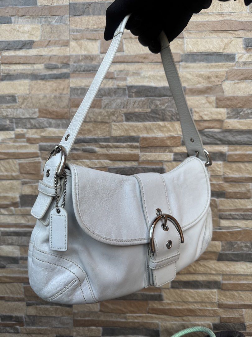 Coach Soho Leather Shoulder Bag (9248) (Category: Luxury Bags & Wallets) located in Cavite. Submitted by justbrowsing_decluttering (Listing ID 1446244737, Image 2). Description: Shoulder Bag 1 Full Back Pocket | 1 Zip Pocket inside Color: White with Silver Tone Hardware Size: Medium Material: Genuine Leather [Colors may vary due to lighting. Bags are Preowned so it will Not be Perfect; Unless stated new.] Signs of use sa leather Guaranteed Authen
