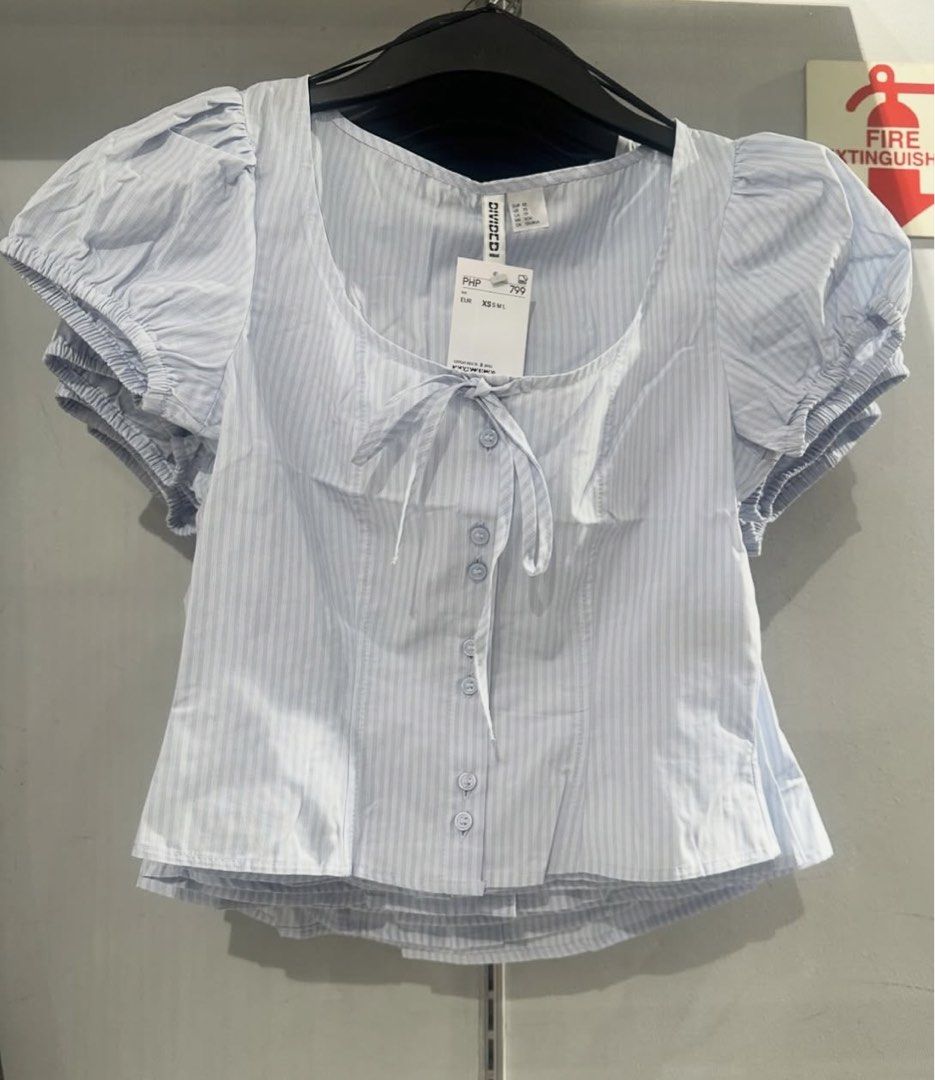 DIVIDED Blue Striped Puff Sleeve Tie Neck Top (Category: Blouses) located in Manila. Submitted by mia67 (Listing ID 1446114446, Image 1). Description: -bought @ H&M rob mag -no tag but haven’t worn -original price is 799.