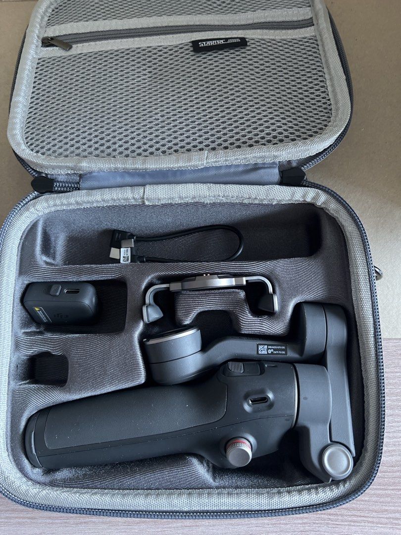 DJI Osmo Mobile Gimbal Stabilizer with Case (Category: Gimbals & Stabilizers ) located in Makati City. Submitted by martine0825 (Listing ID 1446253605, Image 1). Description: - DJI Osmo Mobile 3 Gimbal - Achieve incredibly smooth video shots with your smartphone - Includes original case and all accessories shown - Compact and highly portable for filming on the go - Simple setup and user-friendly operation - Get stable, professional-looking footag