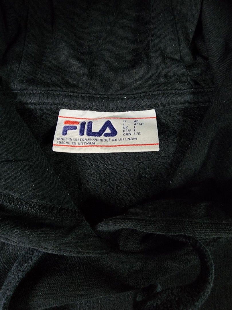 FILA Black Pullover Hoodie (Category: Coats, Jackets and Outerwear) located in La Trinidad. Submitted by closetloop2601 (Listing ID 1446301912, Image 2). Description: 35 0 + SF Size : Large on tag W: 23 in | L: 21.5 in Very good condition Color may vary due to lighting.