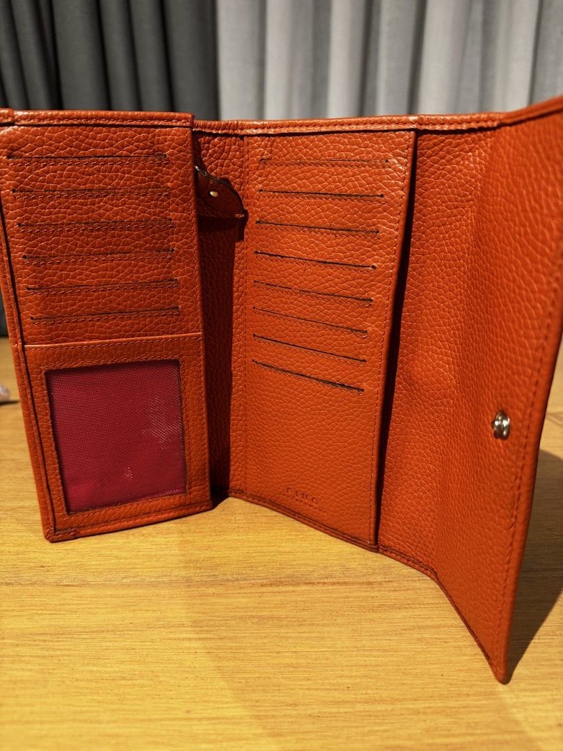 Fino Leatherware Orange Tri-fold Wallet (Category: Wallets & Card holders) located in Mandaluyong City. Submitted by j4yw3e (Listing ID 1446285035, Image 3). Description: - Orange tri-fold wallet from Fino Leatherware - Soft textured leather exterior - Multiple card slots and clear ID window - Secure snap button closure - Perfect for organizing your daily essentials - Used for 3 months. Good as new condition. - Color Rate: 10/10 - Dimensions: L- 