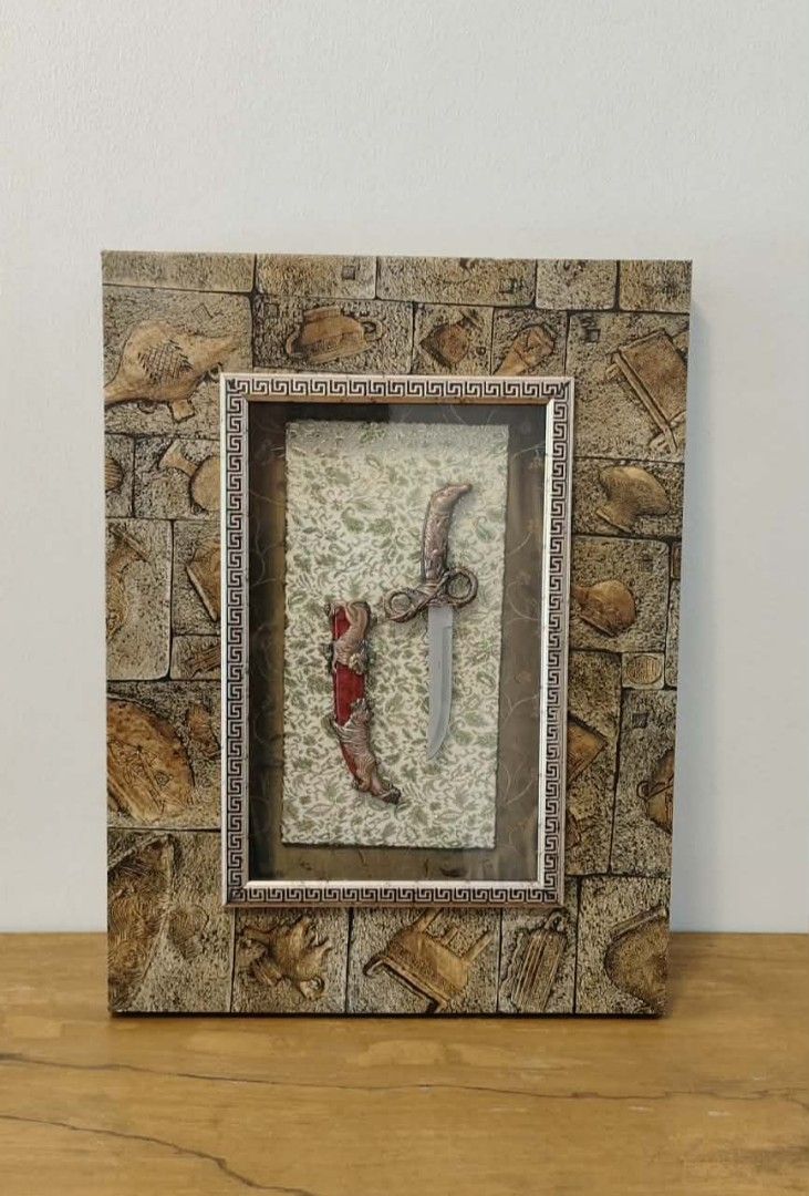 Framed Dagger and Sheath Display (Category: Wall Decor) located in Taguig. Submitted by thrifthub.ph (Listing ID 1446282641, Image 3). Description: Unique wall decor piece. Features a decorative dagger and sheath encased in a textured frame. The frame has a stone-like appearance with embossed details. Great for adding a statement to any room..