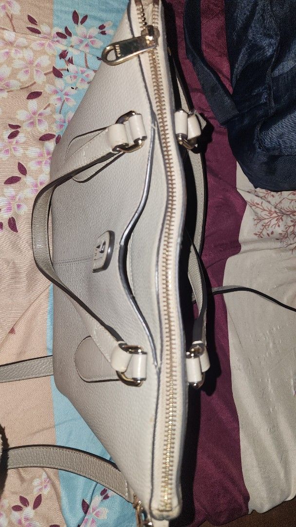 Furla Leather Handbag (Category: Luxury Bags & Wallets) located in Manila. Submitted by noturprinc55624 (Listing ID 1446200442, Image 3). Description: - Light grey Furla handbag - Textured leather material - Top handles and detachable shoulder strap - Secure zipper closure - Interior: 1 zipped pocket, slip pockets - Elegant gold hardware details - Condition: Clean inside and out - Ideal for everyday use -Japan bought/Legit/care card .