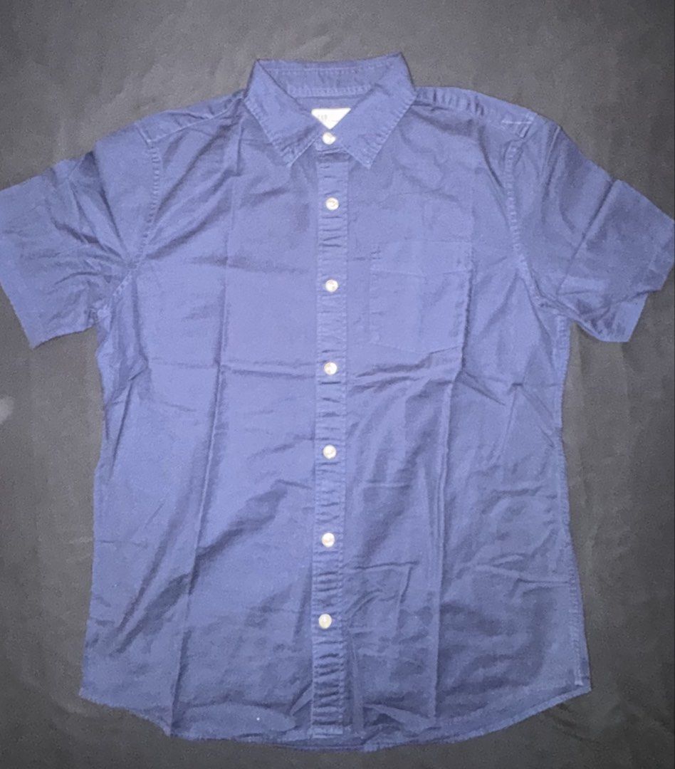 GAP Standard Fit Stretch Short Sleeve Button Up Shirt (Category: Tshirts & Polo Shirts ) located in Taguig. Submitted by crossmill23 (Listing ID 1446328005, Image 1). Description: - Brand: GAP - Color: Navy Blue - Style: Short Sleeve Button Up Shirt - Fit: Standard Fit with Stretch - Size: S - Closure: Button Front - Features: Single Chest Pocket - Versatile: Great for casual wear or dressing up. - RFS: Outgrown.