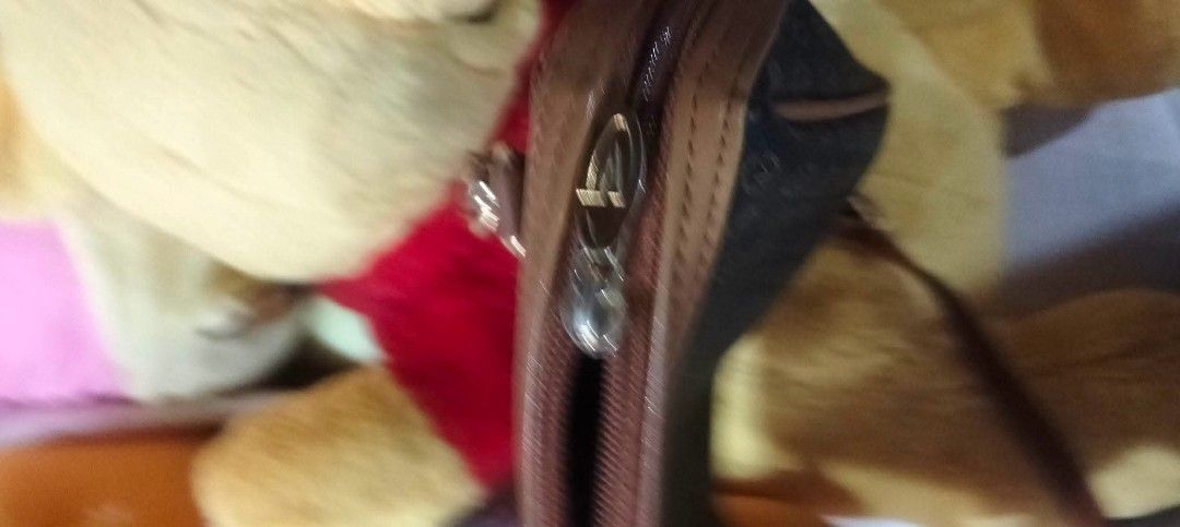 gianni valentino Monogram Shoulder Bag (Category: Luxury Bags & Wallets) located in Urdaneta. Submitted by japanluxurybagsbymcbags (Listing ID 1446342611, Image 3). Description: - Stylish brown and tan monogram shoulder bag - Genuine leather trim and strap - Elegant gold chain detailing - Secure zipper closure - Interior brand tag - Ideal for everyday use.